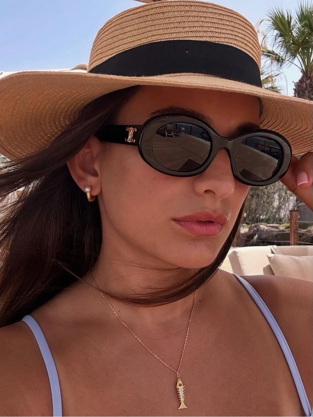 C. Black Oval Sunglasses with Gold Logo Accent